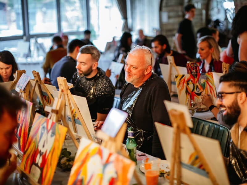 Men enjoying a paint and sip class